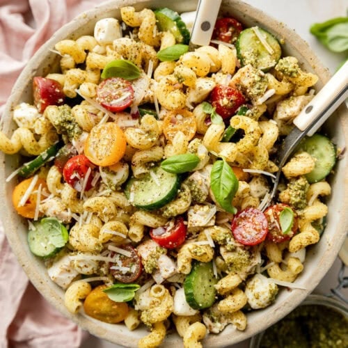 Overhead view stone bowl filled with chicken pesto pasta salad